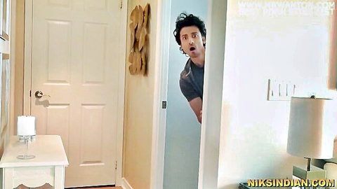 Surprised Indian man peeking from bathroom door in gray t-shirt, desi amateur tease
