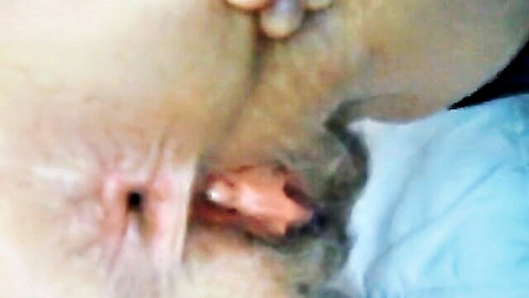 Close-up of mature hairy pussy gaping wide with visible pink insides and puckered anus