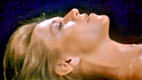 Seductive blonde MILF tilts head back with parted lips in vintage retro porn close-up
