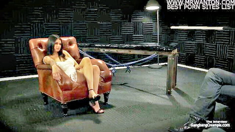 Latina beauty bound to leather chair in skimpy white dress with legs spread for rough gangbang interview