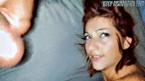 Seductive redhead with smoky eyes smiles on bed while massive pale ass cheeks dominate foreground