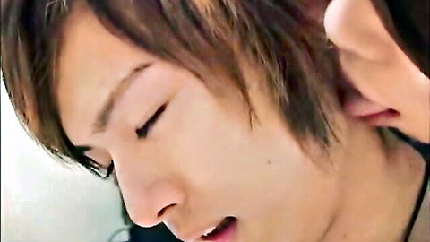 Close-up of sensual Asian twink's handsome face with half-closed eyes and parted lips