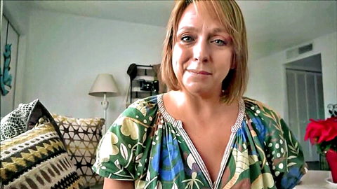 Blonde MILF stepmom in low-cut floral dress teases with cleavage