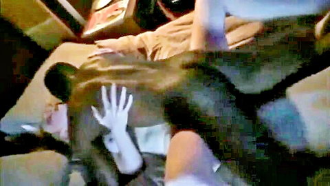 White hand spreading muscular black man's bare ass cheeks on bed