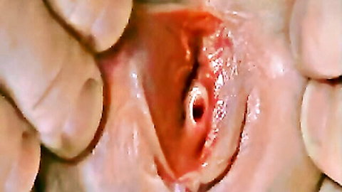 Fingers spreading open wet pink shaved pussy lips exposing tight vaginal hole close-up