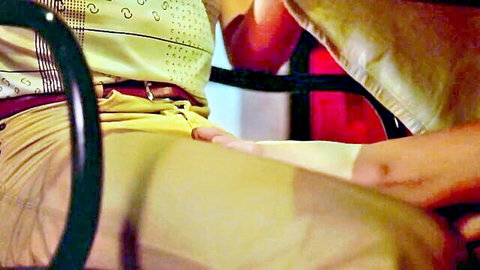 Vintage 1978 Felicity scene: woman in yellow outfit with hand fondling crotch in car