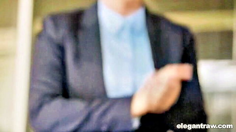 Blurry suited businesswoman in blue shirt crossing arms in office setting
