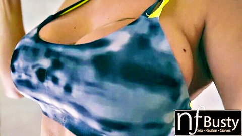 Peta Jensen in blue tie-dye bikini top, deep cleavage and massive breasts