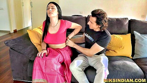 Sexy Indian woman in pink saree gets back massage from man on couch