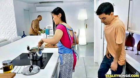 Petite Asian babe in skimpy apron cooks while guy gropes her ass from behind