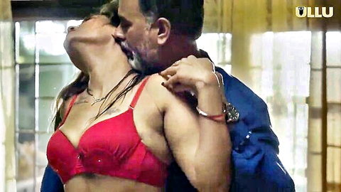 Busty Indian MILF in red bra passionately kissing bearded man with deep cleavage exposed