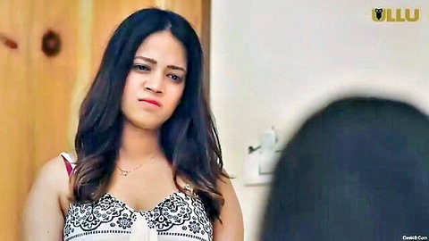 Indian woman in lacy lingerie top, seductive gaze for erotic handjob scene