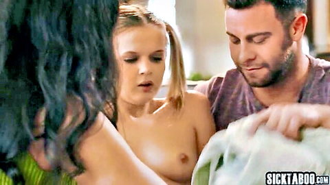 Topless pigtail blonde teen and busty brunette expose tits to guy holding towel in steamy threesome
