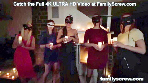 Masked petite women in dresses hold candles in kinky group ritual, teasing lesbian play