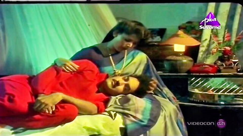 Desi MILF in saree embraces Indian stud on bed, intimate moment