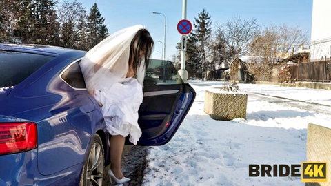 Sofia Lee in sexy white wedding dress entering blue car in snowy outdoor scene