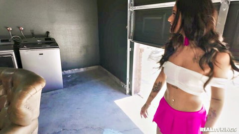 Ryan Reid in white off-shoulder top and pink mini skirt, athletic Latina posing seductively