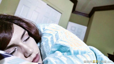 Brunette beauty sleeping peacefully in bed under blue blanket