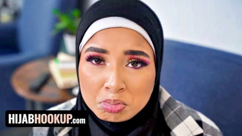 Seductive Arab hijab girl with bold makeup and plump pouty lips teasing