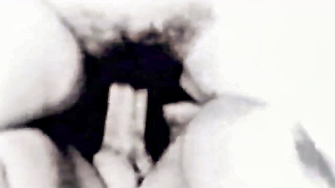 Blurry close-up of saggy natural tits squeezed together in vintage retro porn
