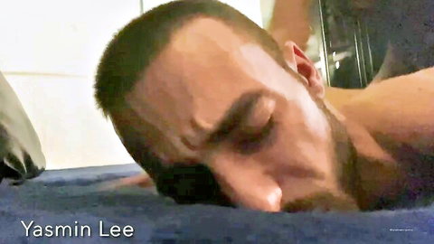 Shirtless bearded man Yemin Lee lying face down relaxed on blue massage table