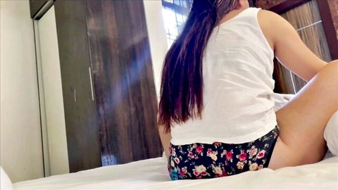 Curvy Indian woman in floral panties teasing big ass on bed from behind