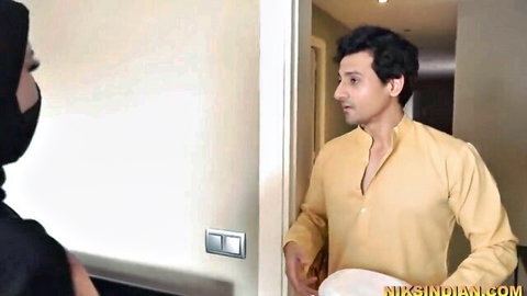 Niqab-clad Indian hijabi woman in black abaya faces stepbrother in yellow kurta at door in taboo tease