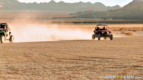 Dune buggies racing through dusty desert with mountains backdrop Brazzers