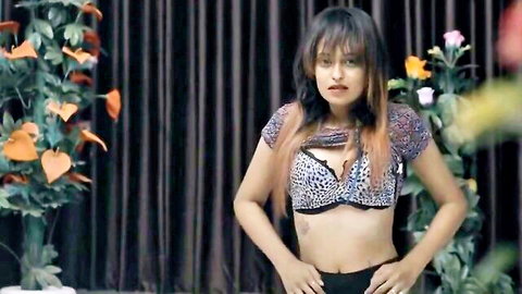 Sexy Indian babe in leopard print bra showing deep cleavage and posing seductively in tight black shorts