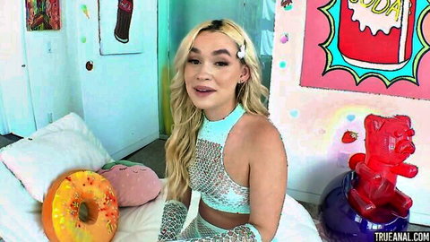 Khloe Kingsley in sparkly green outfit posing on bed