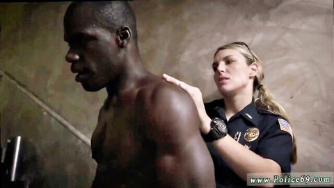 Interracial cop in uniform touches muscular black man's bare shoulder