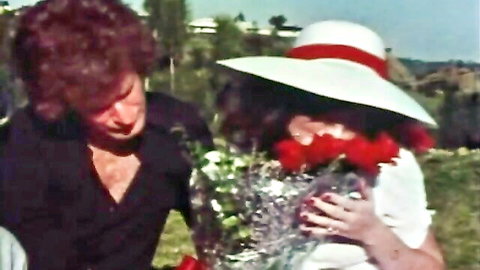 Vintage couple in romantic embrace with red roses and trophy, big naturals tease
