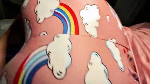 Closeup of cute pink rainbow cloud print pajamas teasing naughty teen pussy