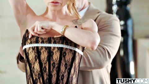 Summer Vixen in black lace corset measured by suited man in naughty MILF scene