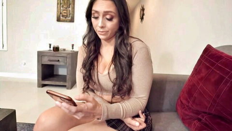 Curvy Latina girlfriend in low-cut sweater teases big tits and thighs checking phone on couch