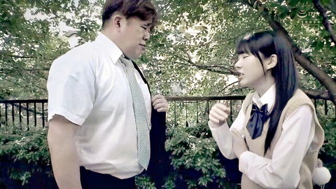 Japanese teacher chats with uniformed schoolgirl outdoors