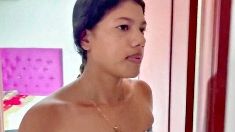 Topless Asian step sister with braided hair smiles seductively