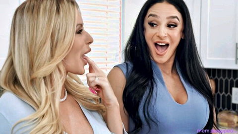 Danielle Renae and Sheena Ryder in blue dresses, teasing intimately