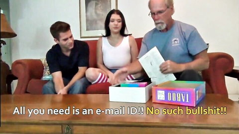 Brunette teen in tight white tank top and striped socks sits with stepdad and stepbro playing naughty board game
