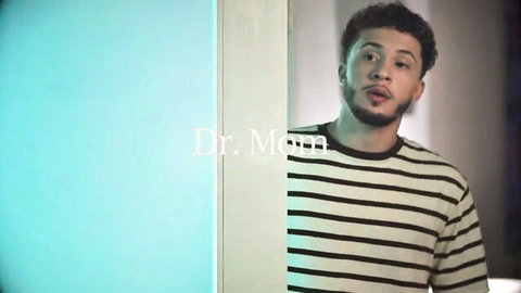 Bearded guy in striped shirt smirking through doorway in Dr. Mom roleplay