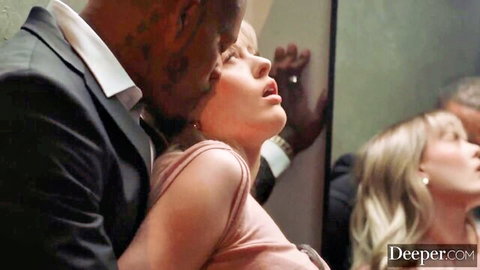 Amber Moore in pink dress embraced passionately by black man in cuckold scene