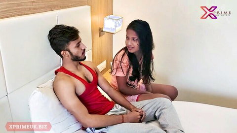 Indian couple in bedroom tease, girlfriend in pink top with boyfriend