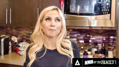 Blonde MILF pouting seductively in kitchen with Out of Family logo