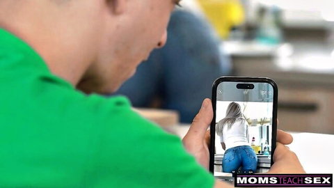 Guy watches busty blonde MILF bend over showing tight jeans ass on phone screen