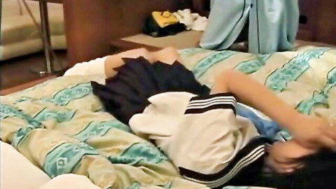 Japanese schoolgirl skirt hiked up exposing panty-clad ass on bed
