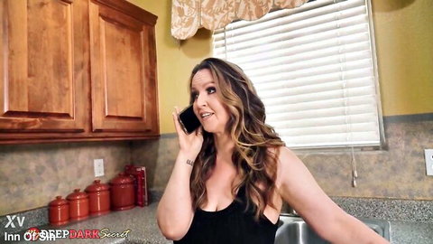 Violette Blakk on phone in kitchen, teasing in black tank top