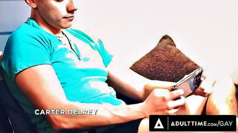 Carter DelRey lounging casually in teal shirt on AdultTime Gay