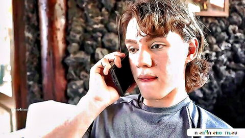 Red-haired young man on phone in kinky threesome setup