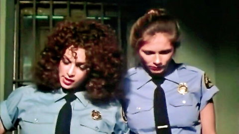 Vintage lesbian prison guards in sexy blue uniforms behind bars