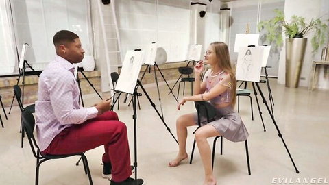 Skinny young blonde in short skirt sits legs apart teasing black artist in art studio class